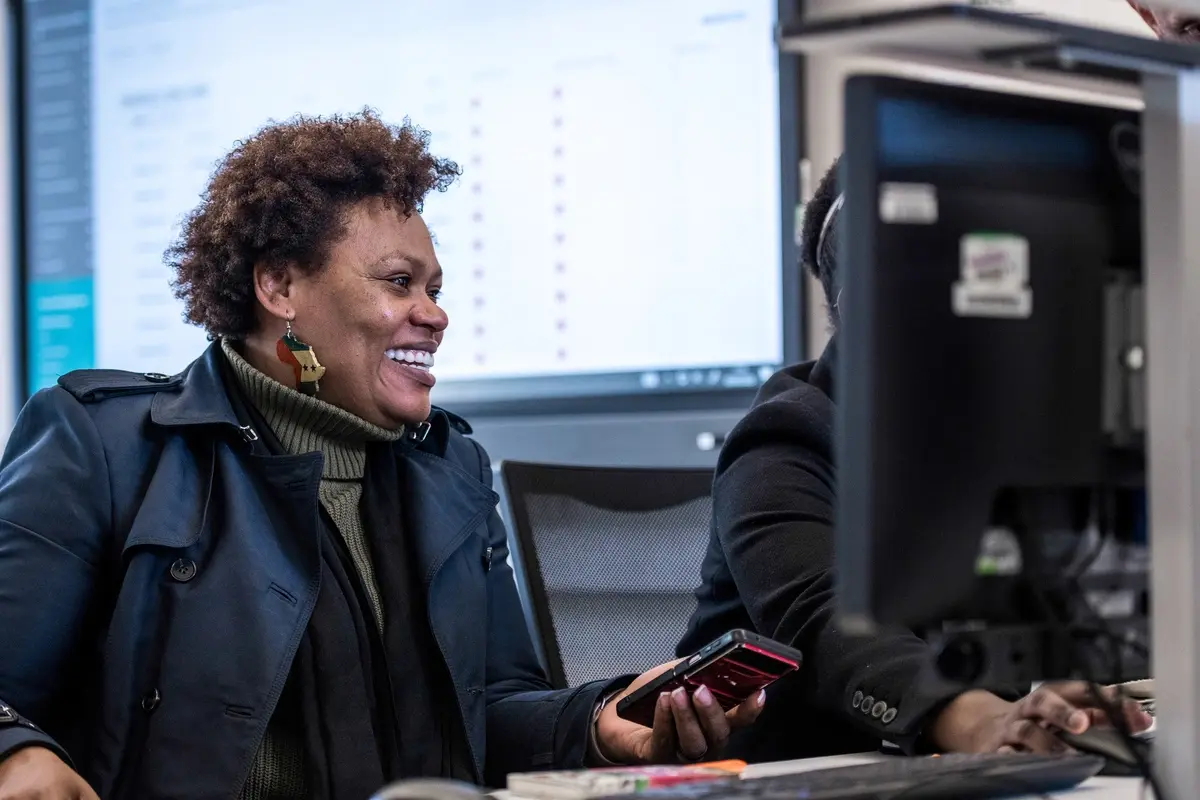 Student smiling at computer 