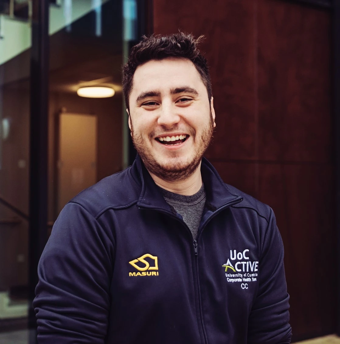 A member of staff smiling.
