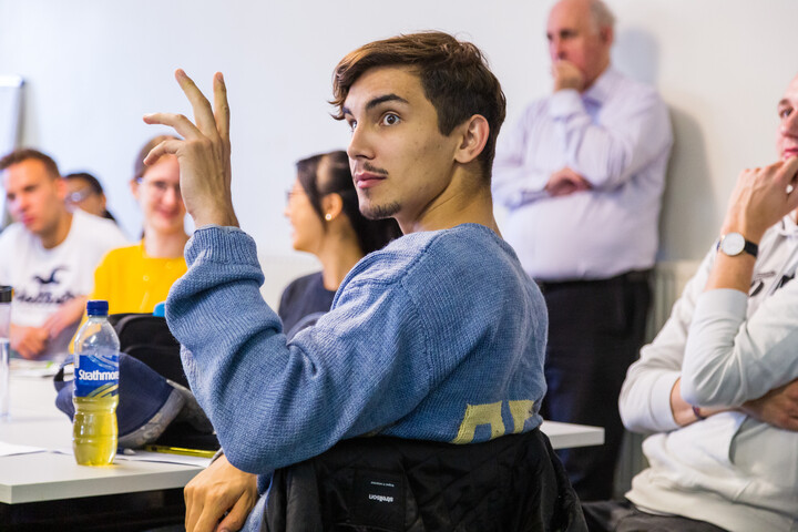 A man raising his hand.