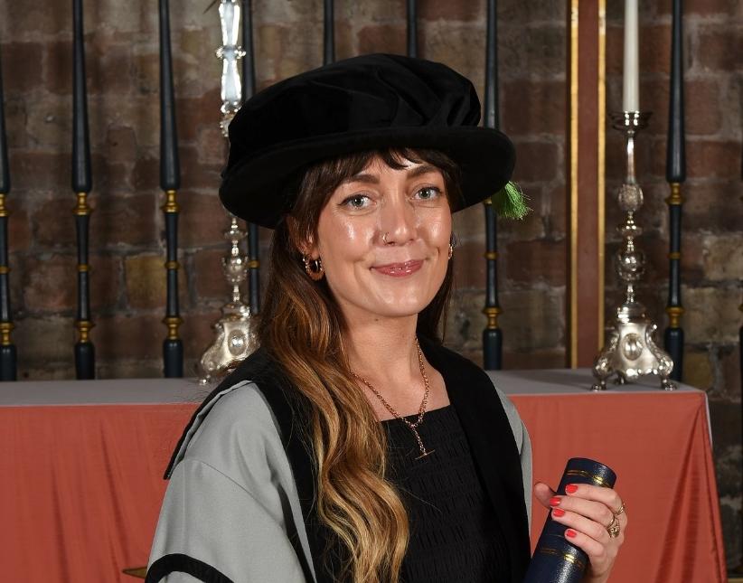 A group of graduates take a selfie together.