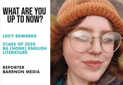 Lady with red hair, an organge beanie hat and glasses