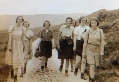A group of 1940s women hiking in the Lake District in skirts and boots