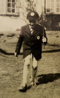 Black and white image from 1950s showing a young school boy in uniform