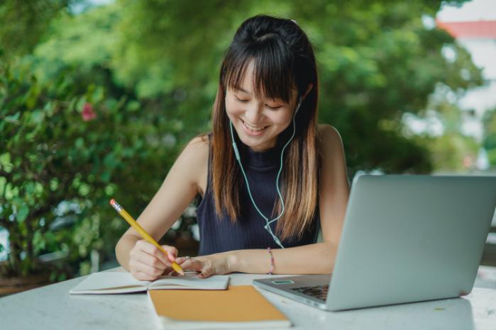 A student takes notes from her laptop.