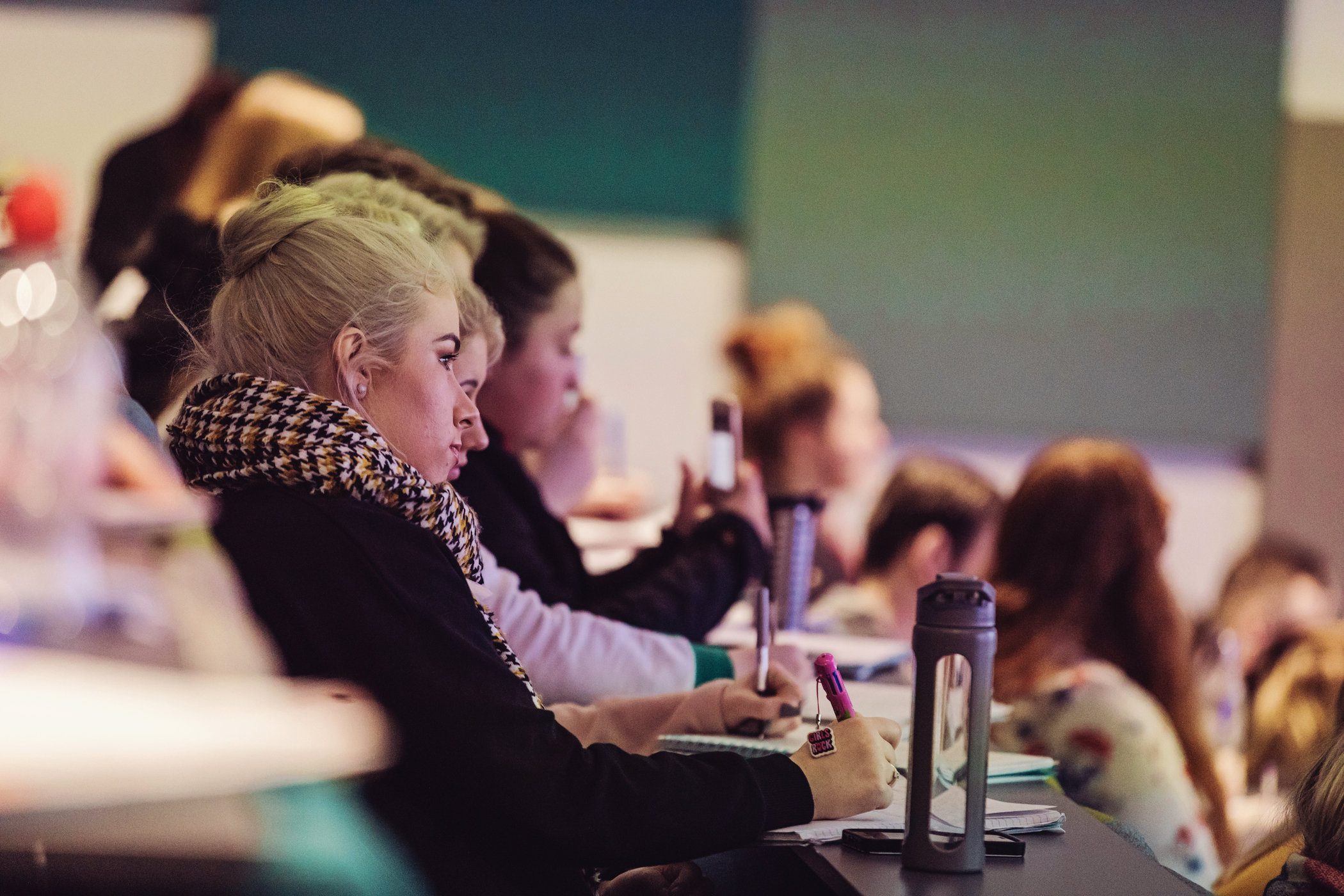 A student taking lecture notes.