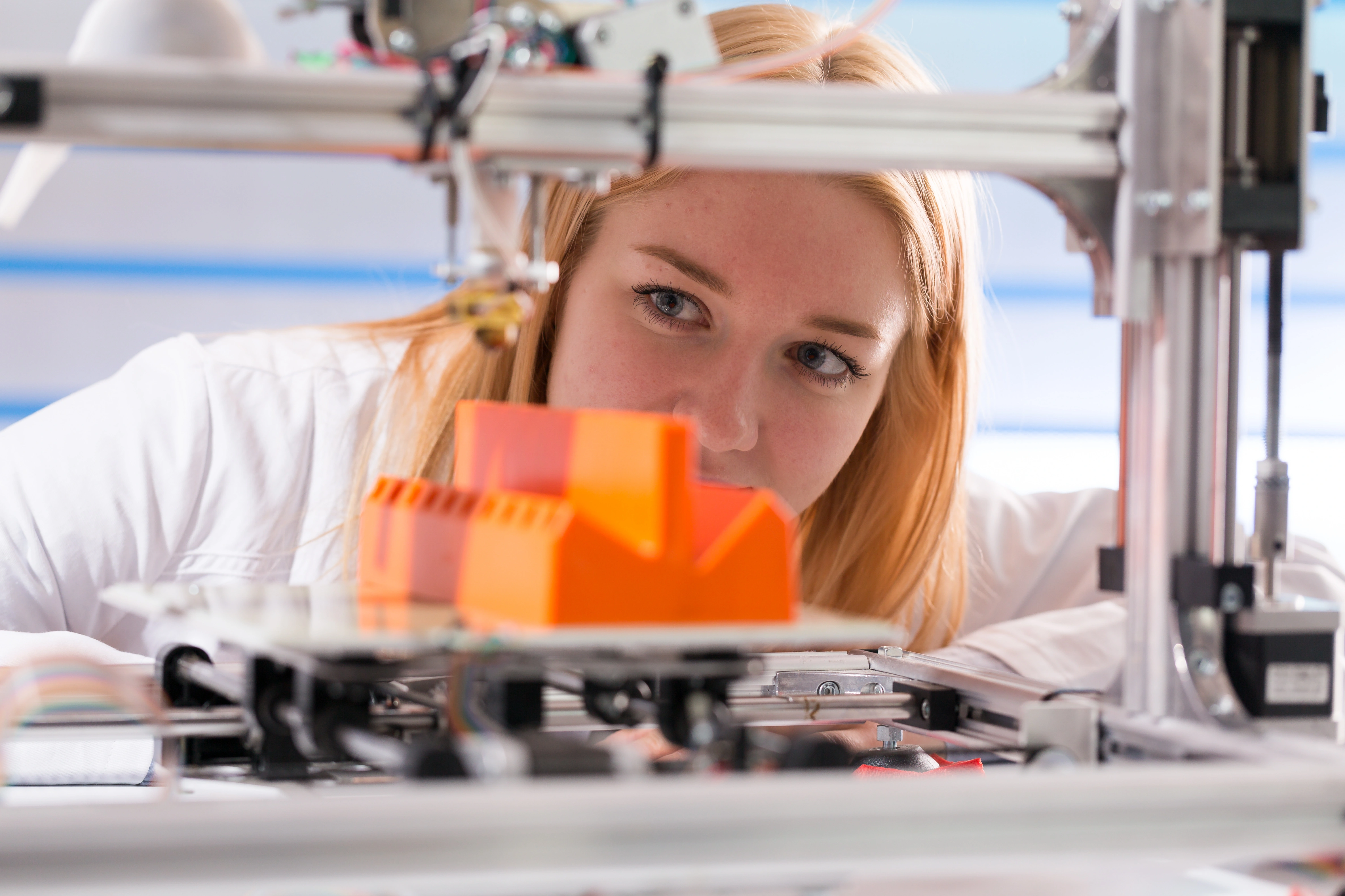 Student with a 3D printer.