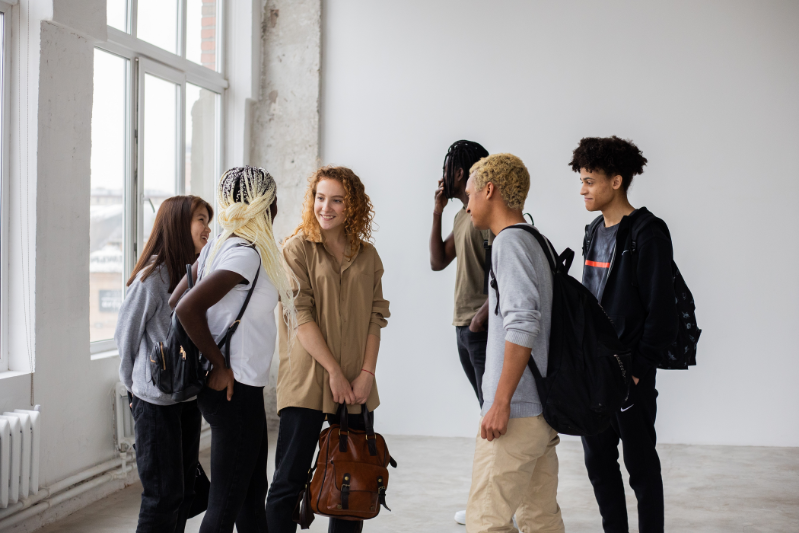 A group of young students chatting.