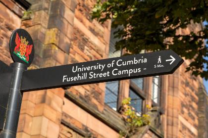 Street sign pointing right, towards Carlisle Fusehill Street campus