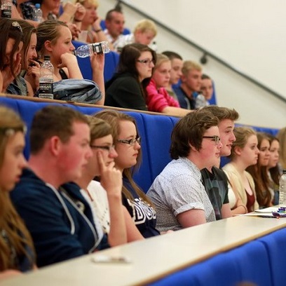 Students seated in a lecture hall facing towards the speaker.