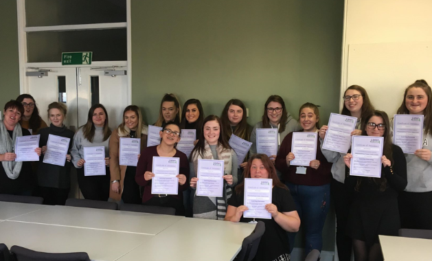 WCF Students 2, A group of students standing together and showing their certificates to the camera