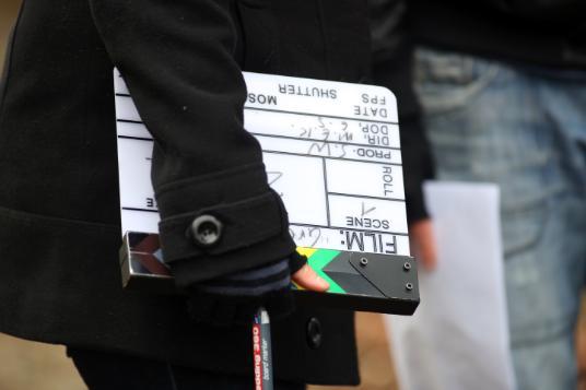 13_reasons_film, A close up of an upside down film clapperboard being held in the hand of an unknown person.