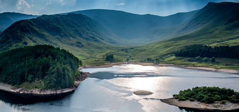 Rolling mountains of the lake district and a shimmering lake 