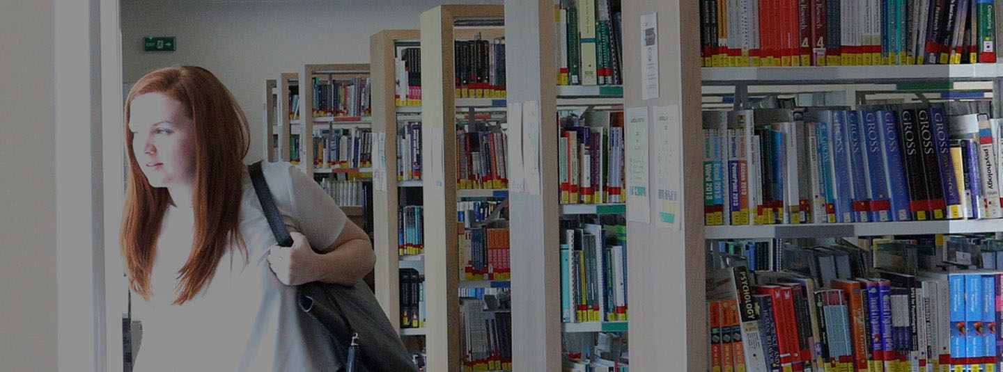 A student walking in the library