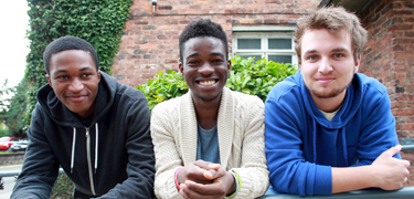 Three boys smiling 