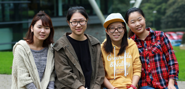 Group of students sat together smiling 