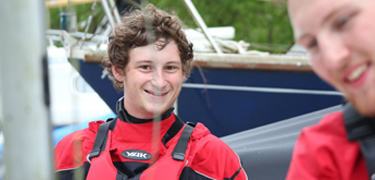 Two boys near boats