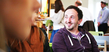 A girl and boy smiling at each other 