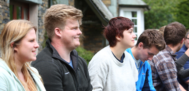 Group of students sat together smiling 