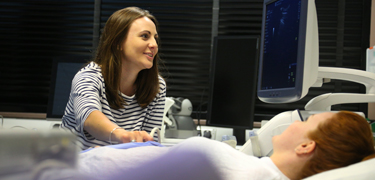 Health student using ultrasound equipment