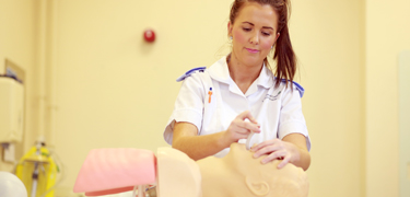 Nursing student using equipment 