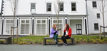 Two people sat on a bench 