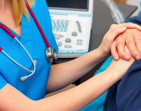 nurse holding someones hand.