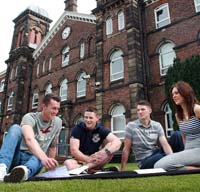 Fusehill Street, Students sitting outside on the grass chatting at Fusehill street campus.