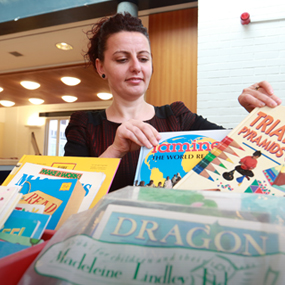 teacher looking at children's books