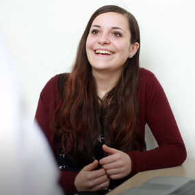 a woman sat smiling 