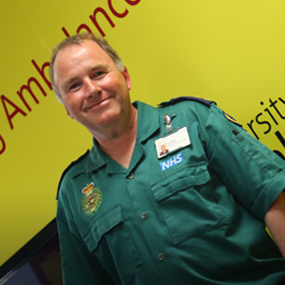 Paramedic stood next to a ambulance 