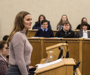 Woman standing at a lectern in a law court