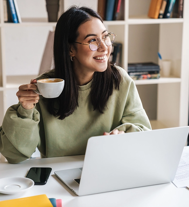Woman on a laptop drinking coffee 