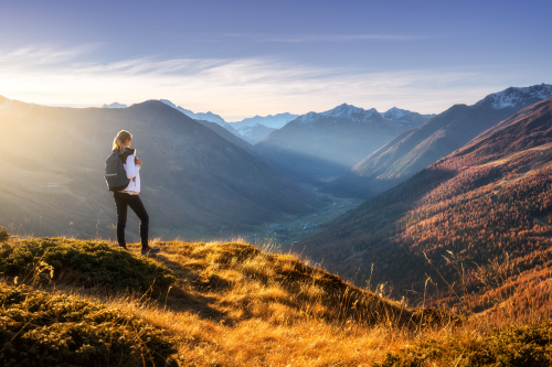 Hiker gazes across misty mountains