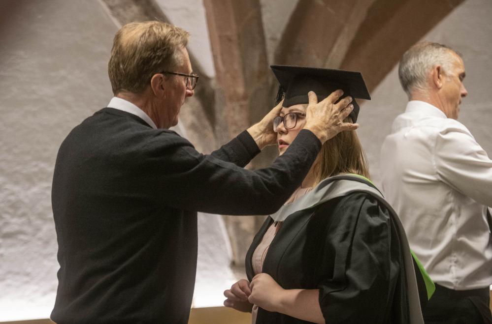 Graduand having mortar board adjusted