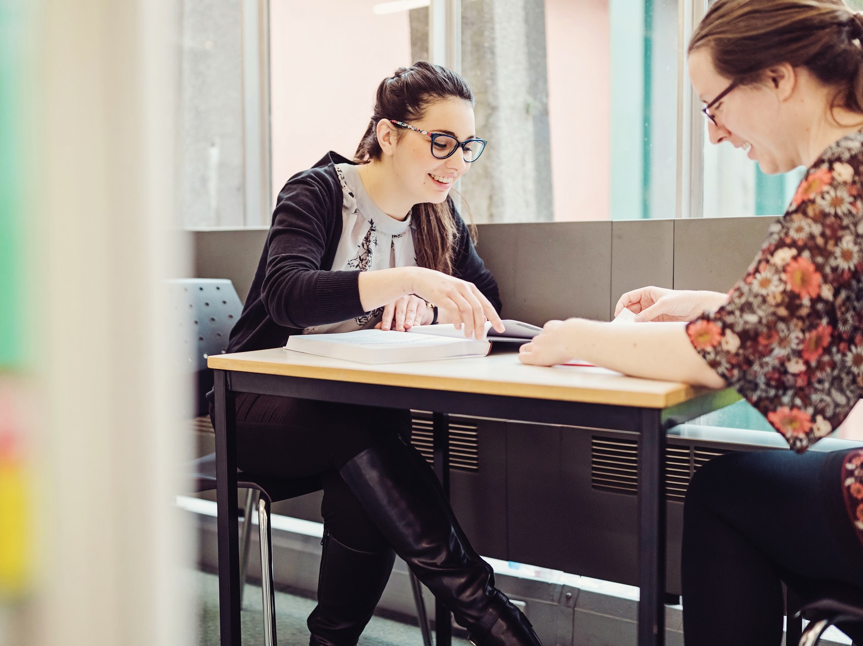 Two students sit reviewing notes.