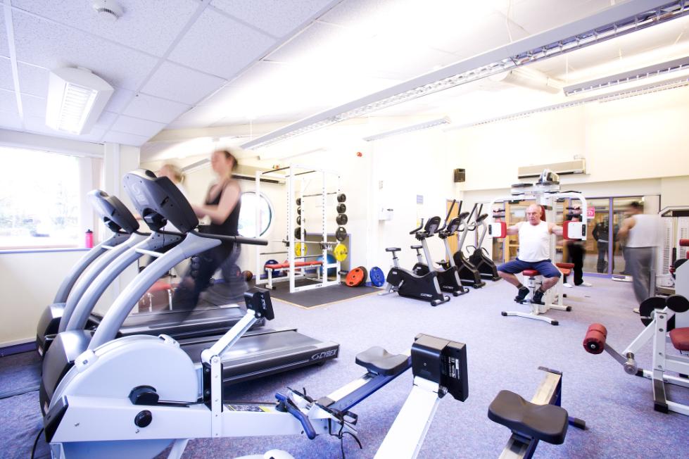 A woman runs on a treadmill.