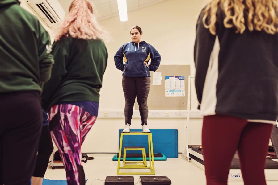 A sports student hosts a fitness class.