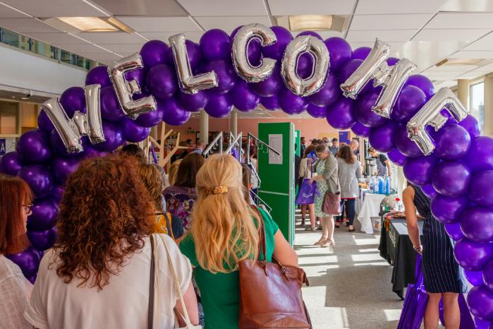 A balloon arch reading Welcome.
