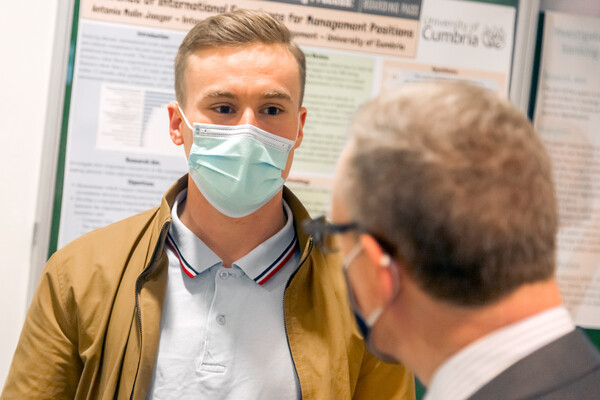 A student listens to a lecturer.