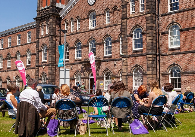 university students seating outside building
