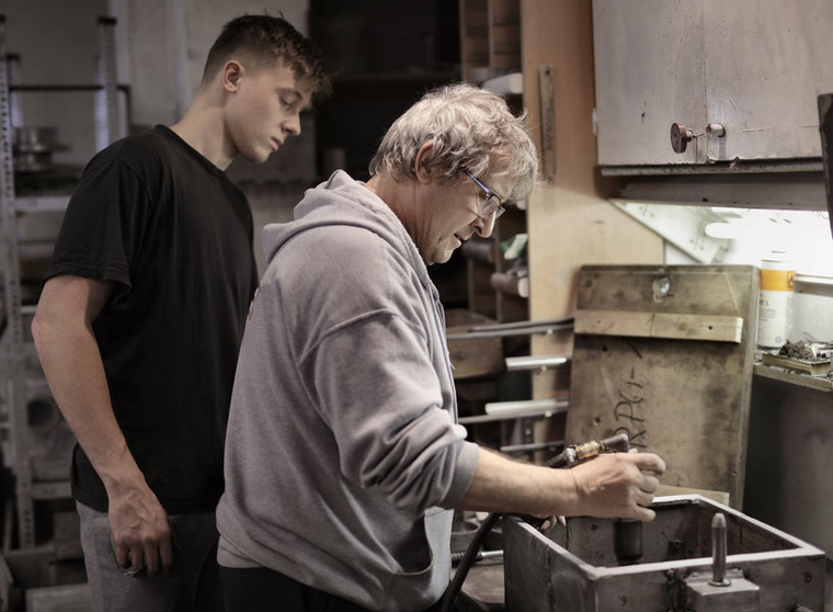 young apprentice working with teacher