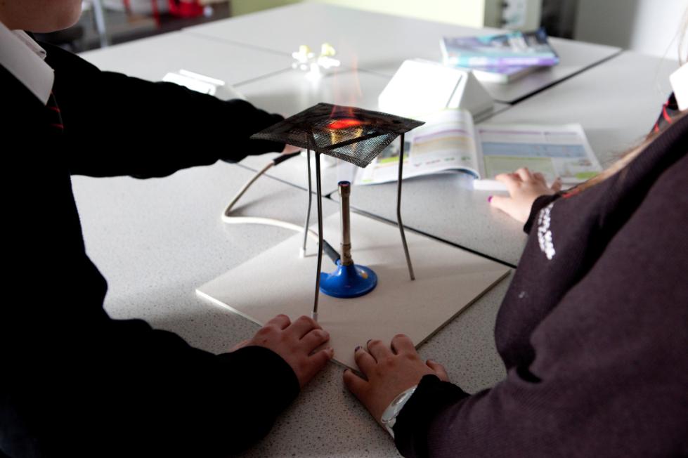 Children use a burner in science