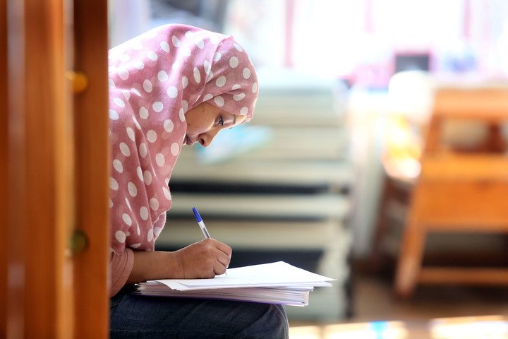 student writing notes
