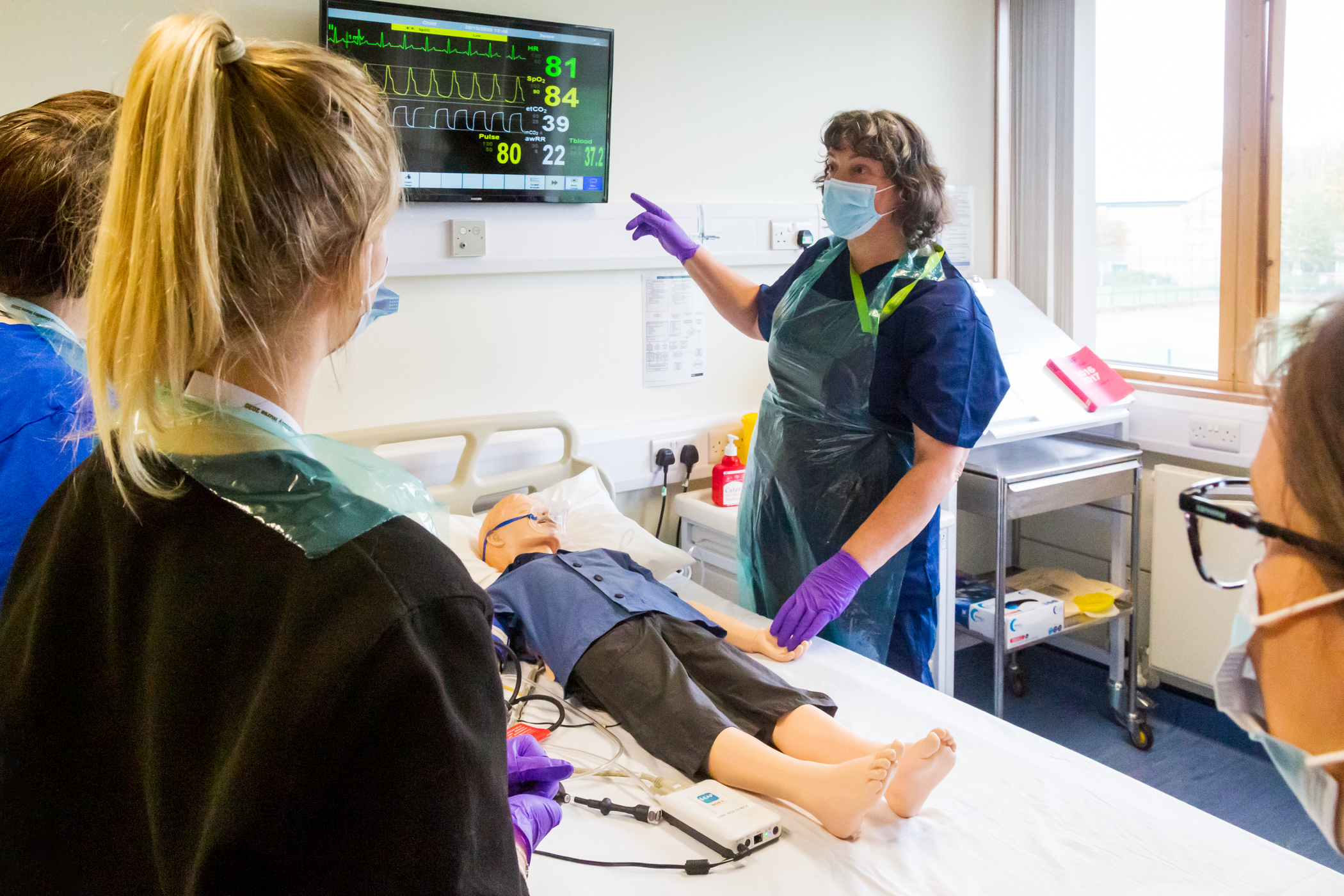 A lecturer with learning disabilities students teaching them basic skills