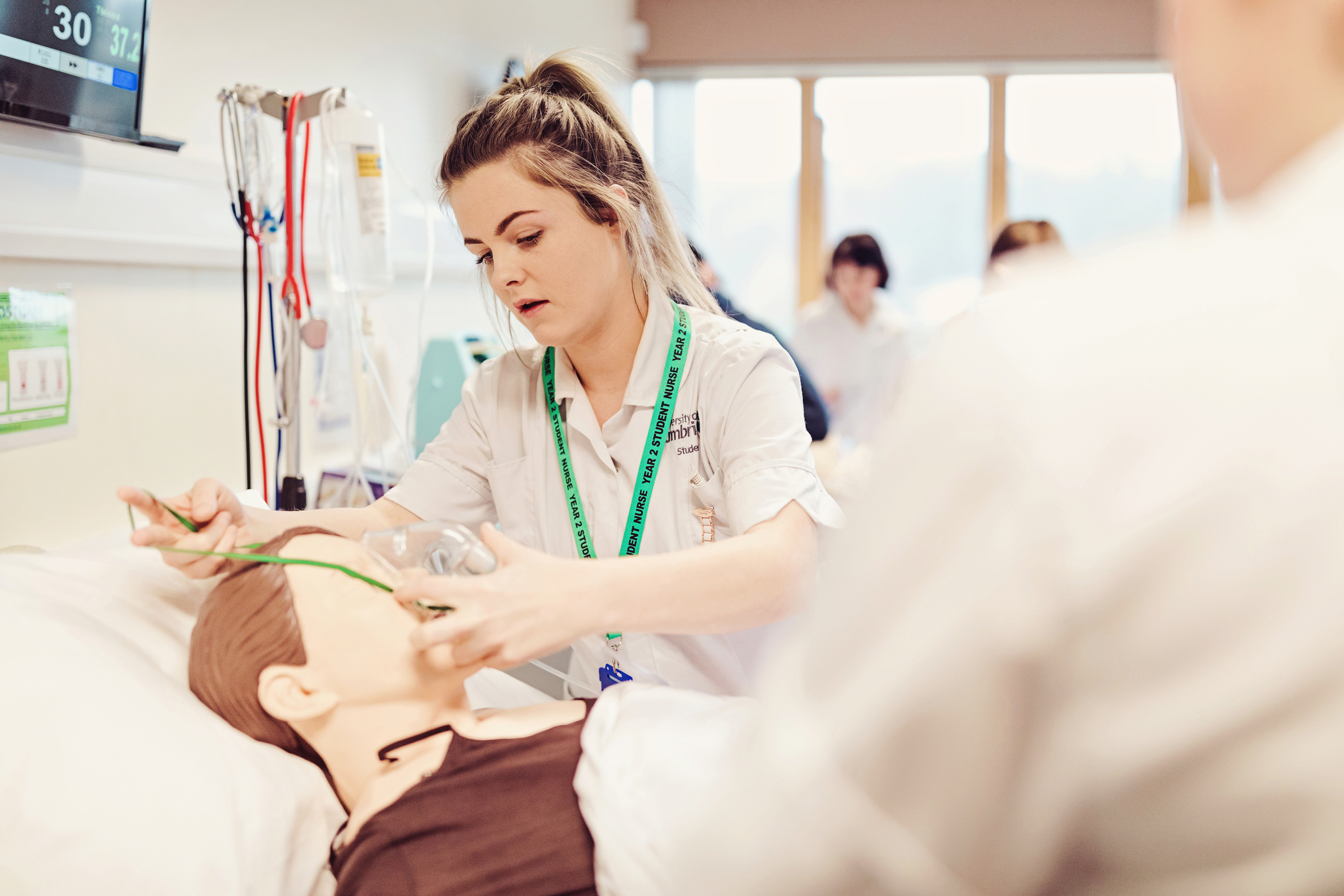 A nursing student in our simulation lab with a simulation doll