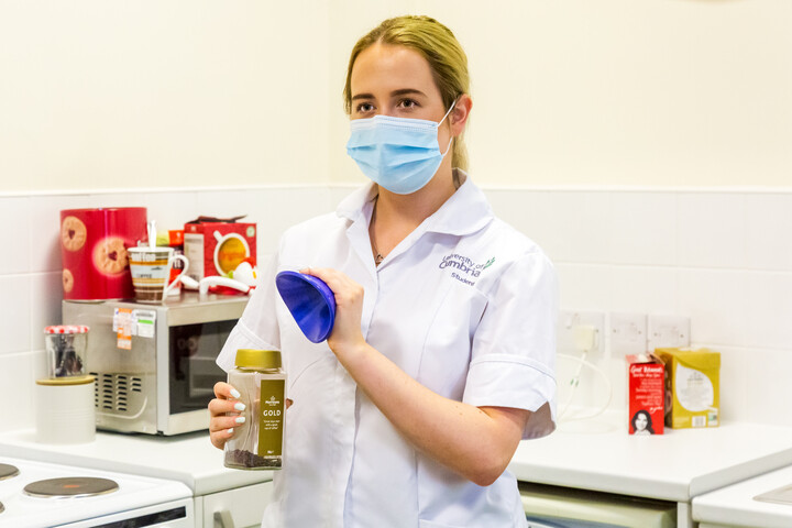 A student showcasing a helpful device for their patients A student showcasing a helpful device for their patients