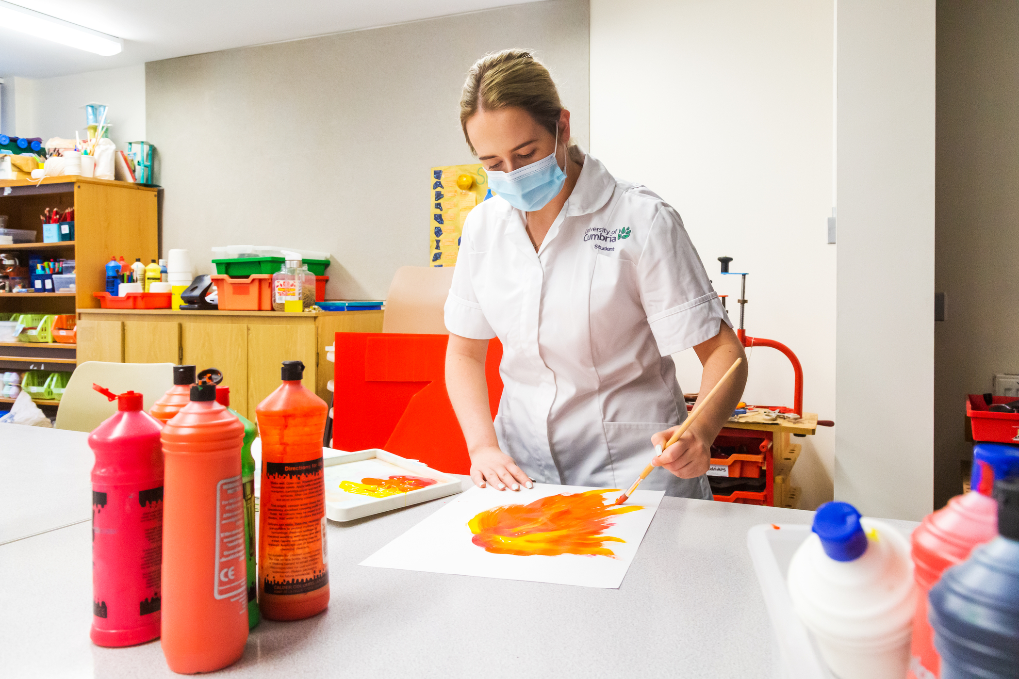 A student learning creative skills to integrate into their care A student learning creative skills to integrate into their care