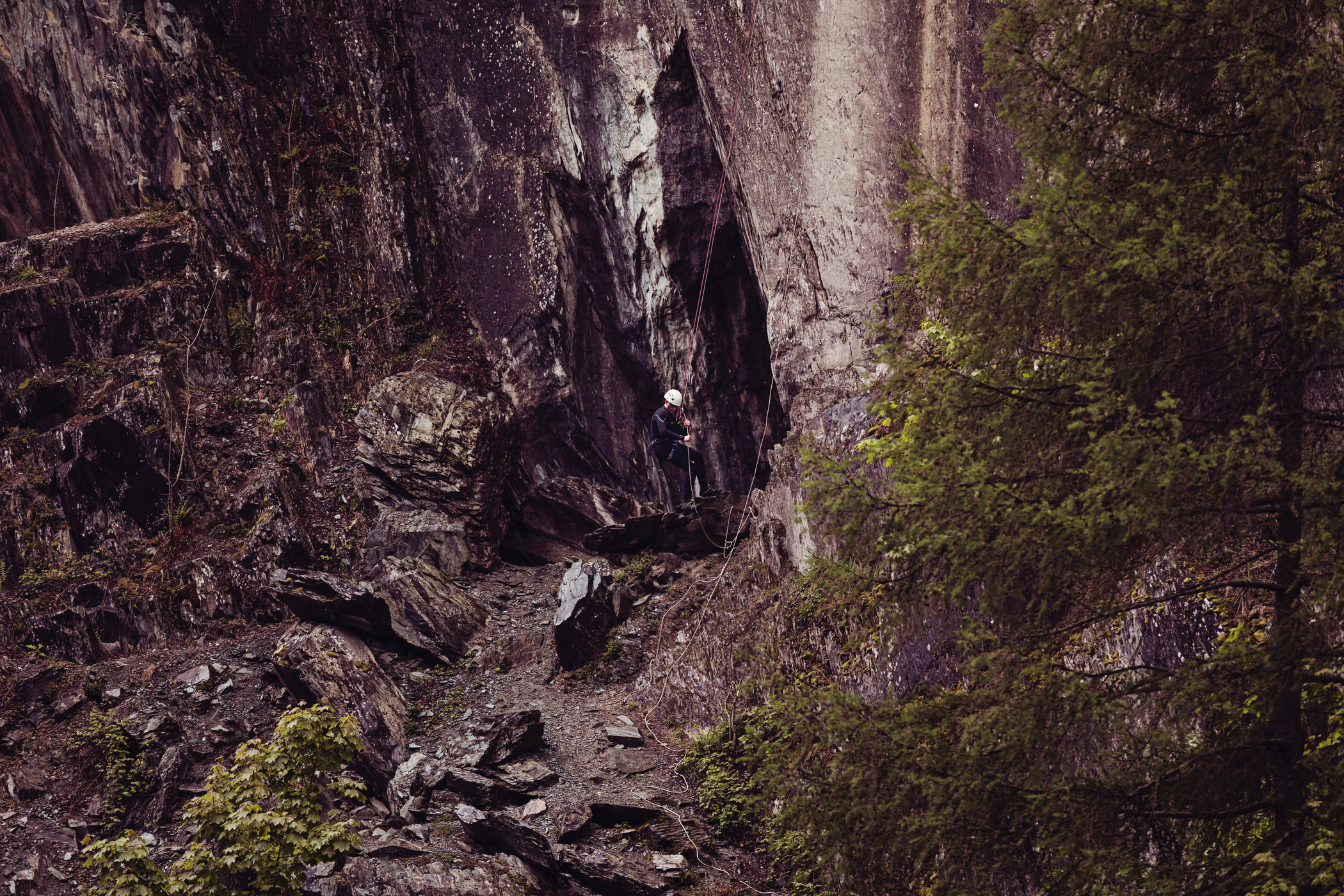 A student scaling down a cliff. A student scaling down a cliff.