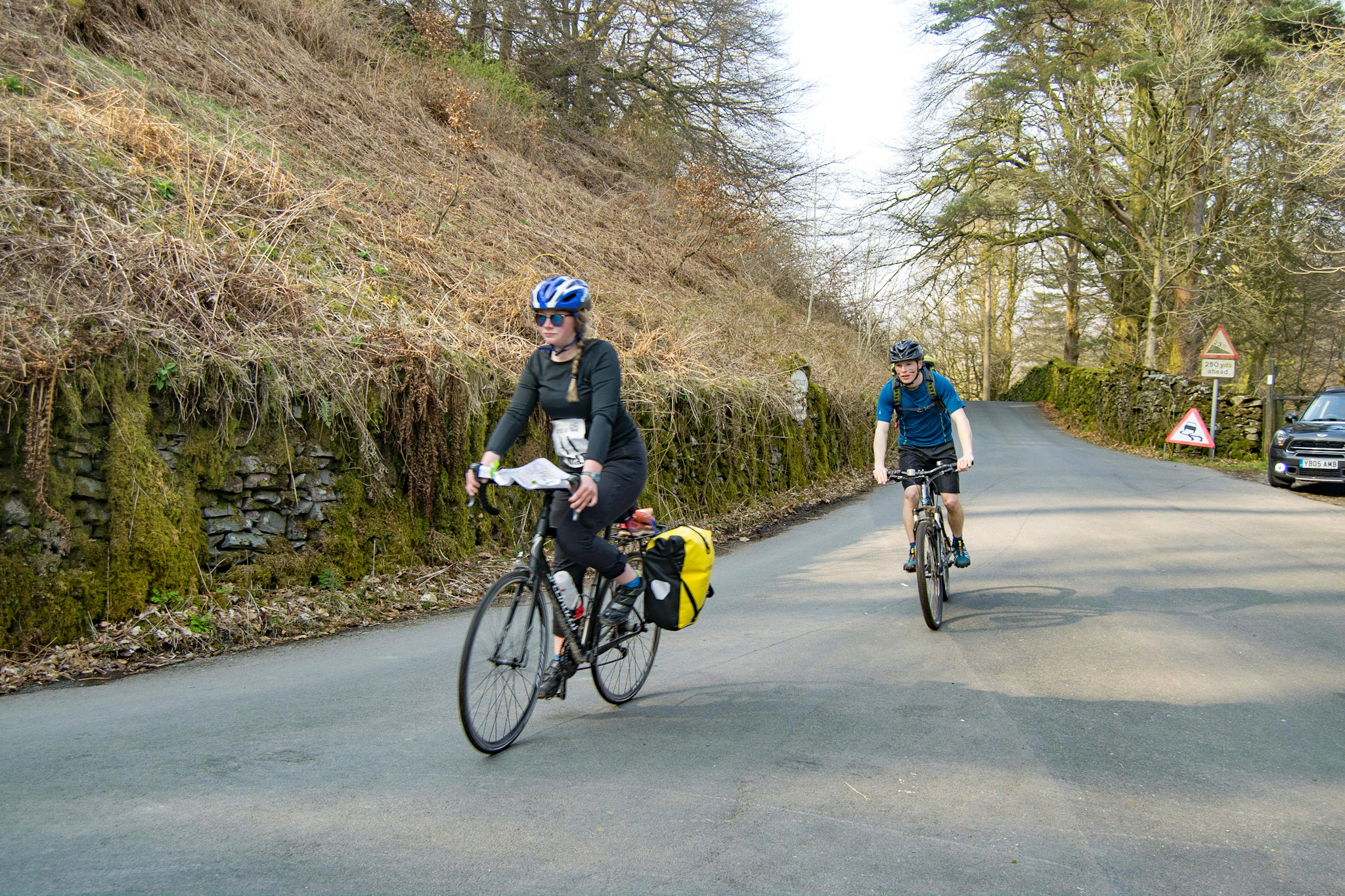 Students cycling on road in Lake District Students cycling on road in Lake District
