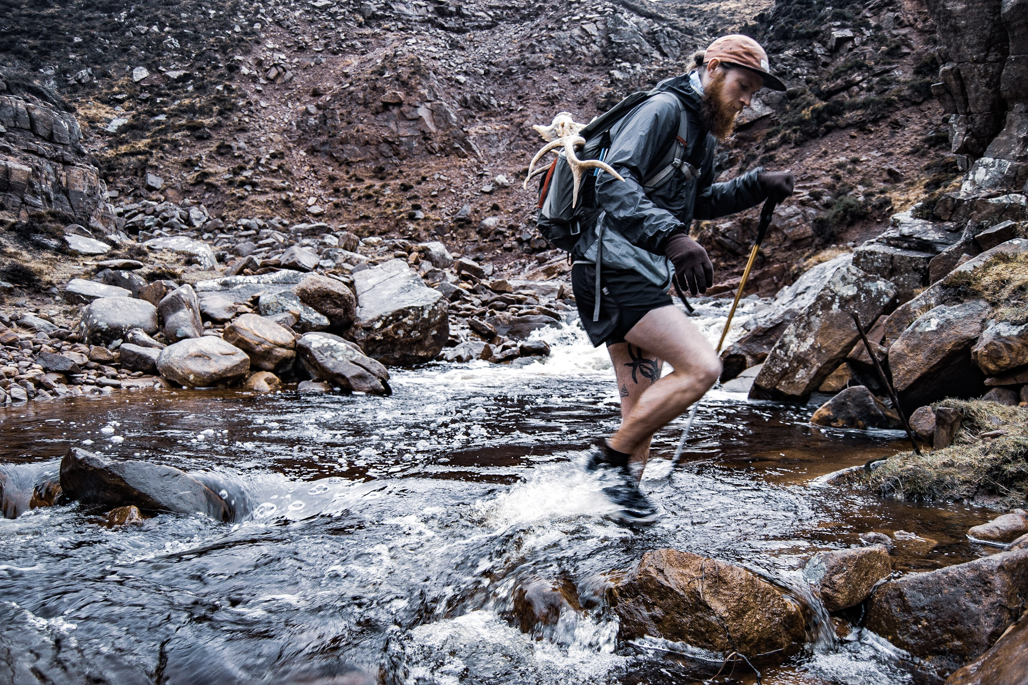 Male student walking through a river Male student walking through a river